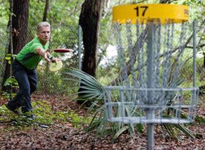 Man throwing a disc at Disc Golf Course at James Island County Park