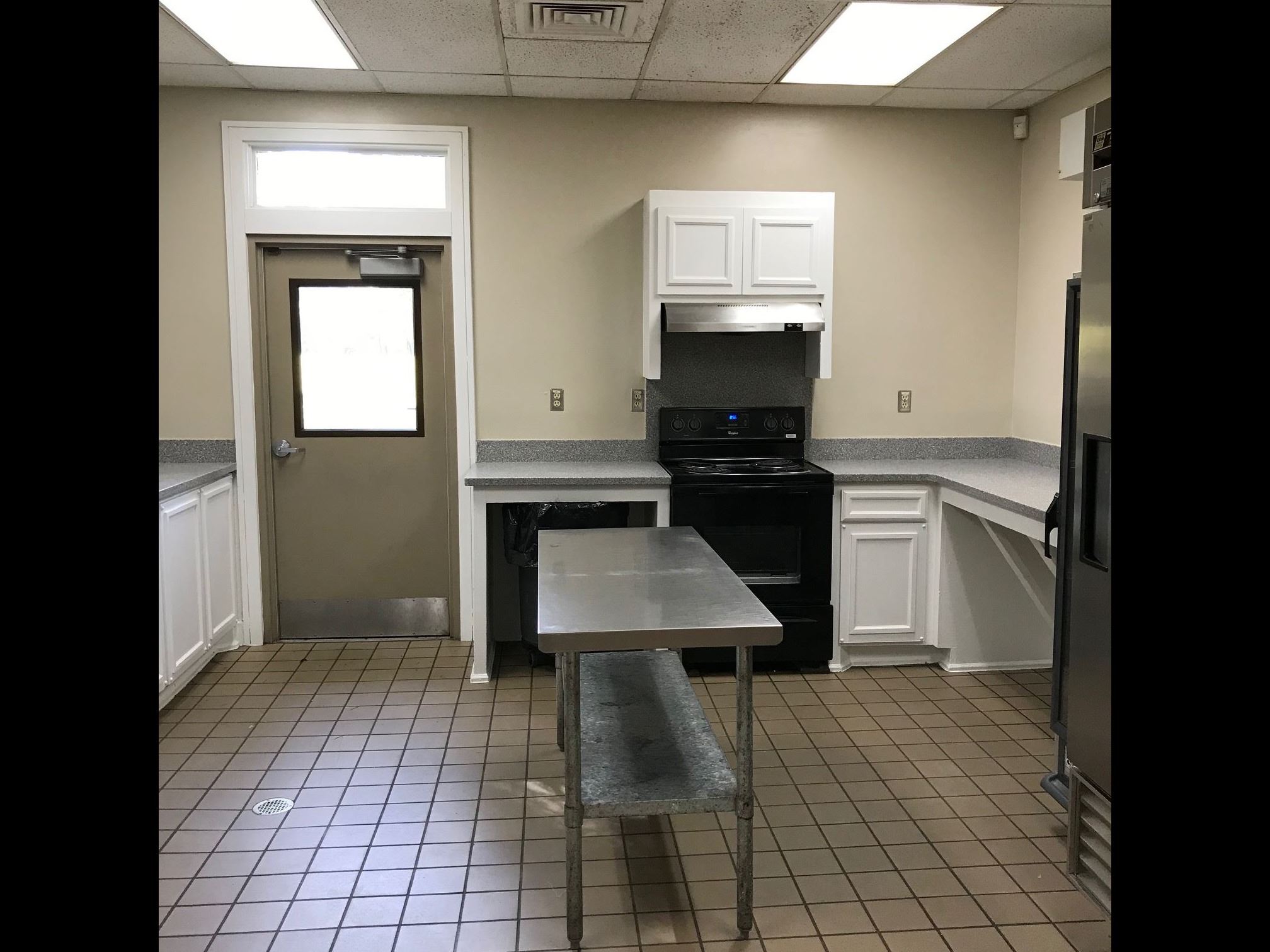Kitchen with island, stove, and countertops