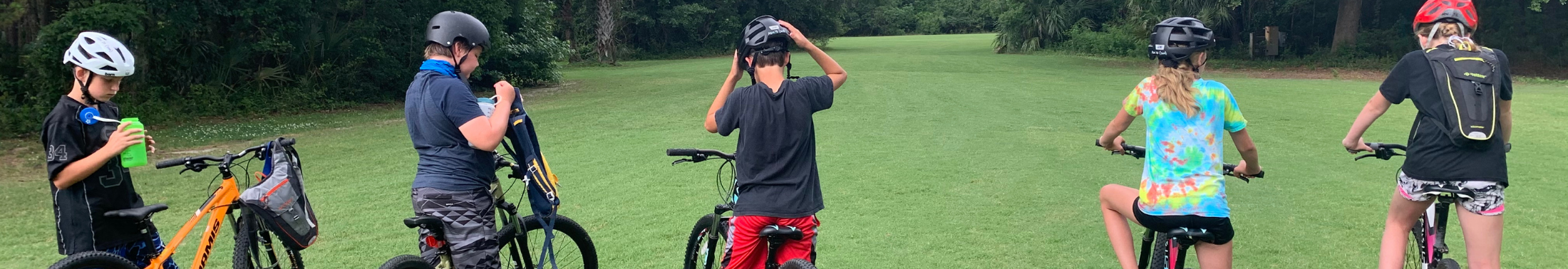 Campers biking in a field