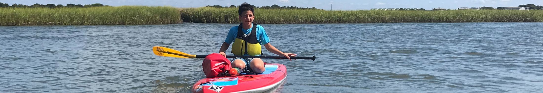Camper paddles in the creek