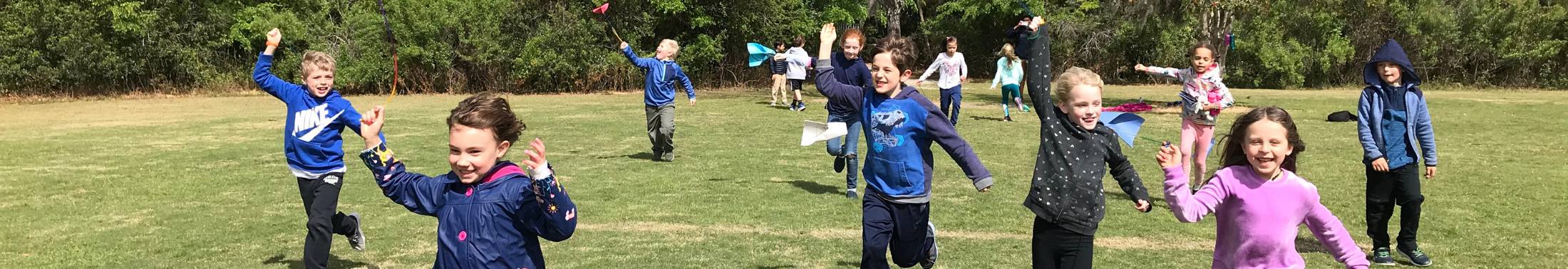 Kids playing with kites in a field