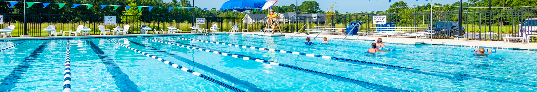 View of the pool and people swimming at West County Aquatic Center