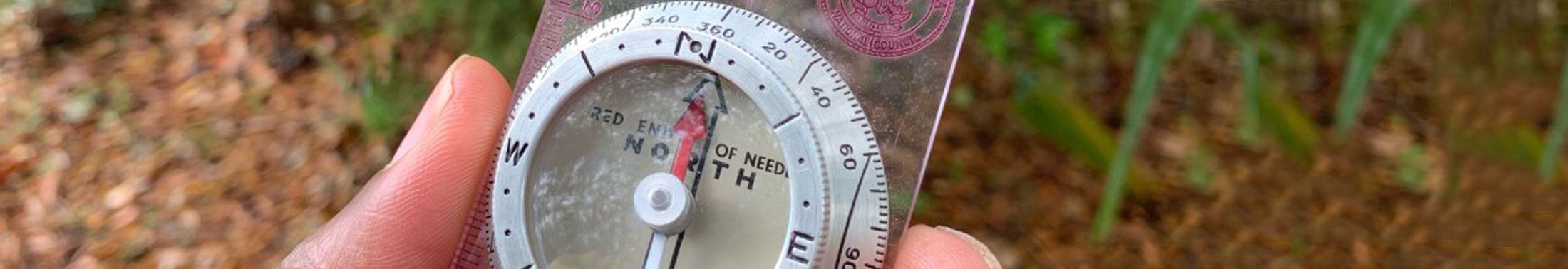 Hand holding a compass