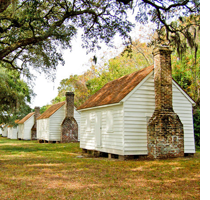 Small white wood Houses of the enslaved at McLeod Plantation Historic Site