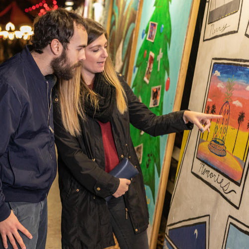 Couple views the Greeting Cards at the Holiday Festival of Lights