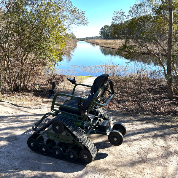Image of a Waymaker Track Chair on a marshview trail in the woods